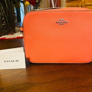 Coral colored Coach purse